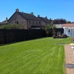 garden alongside house with wooden fence