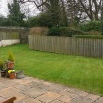 fencing around a garden with concrete walkway