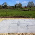 concrete pavement surrounded by gravel stones