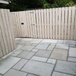 slabbed pavement with wooden fence